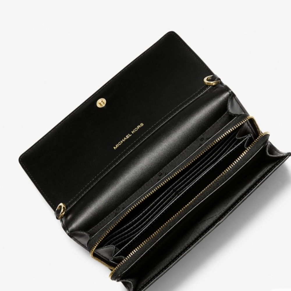 Chic black crossbody with gold accents and bold logo strap.
Perfect for everyday - Picture 10 of 10